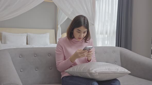  Young woman customer celebrating winning bid or getting ecommerce shopping offer on smartphone. alt