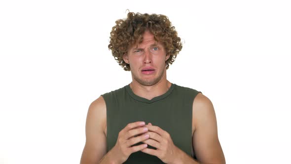 Fairhaired Curly Guy Isolated Over White Background Looking at Camera in Surprise Wondering alt