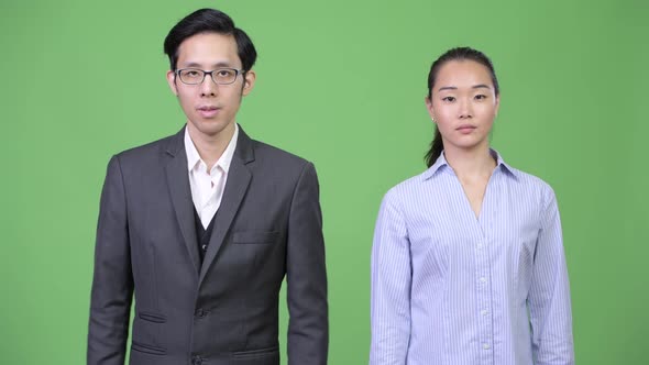Young Asian Business Couple with Arms Crossed Together