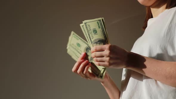 Successful woman checking amount of cash money. Close Up businesswoman hands holding one hundred 