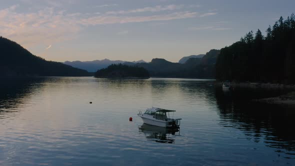 A White Speedboat Anchored At The Sechelt Inlet - Pacific Ocean Fjord On The Sunshine Coast Near Egm alt