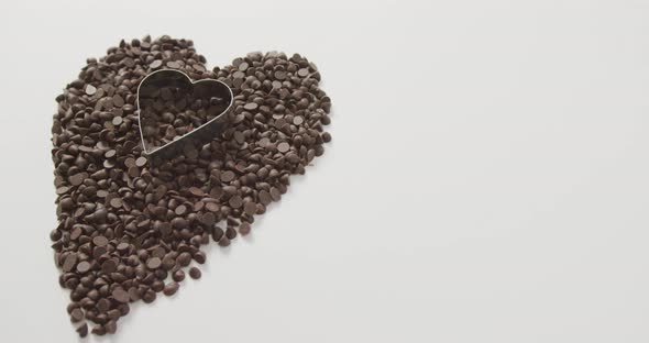 Video of heart formed with chocolate chip and copy space over white background alt