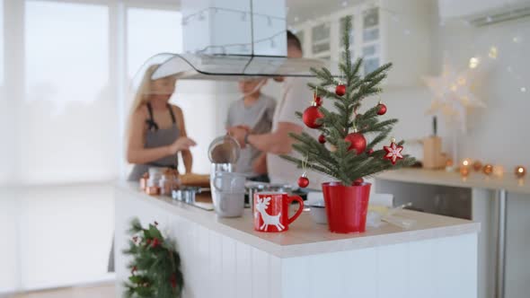 Happy Family Mother Father and Son Baking Christmas Cookies on Cozy Kitchen