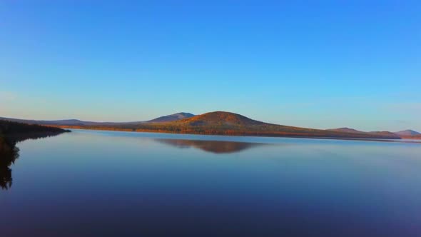 Aerial Video of Beautiful Mountain Lake on a Frosty Autumn Morning. alt