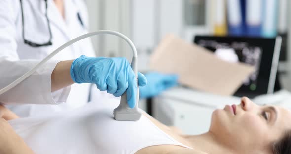 Doctor's Hands with a Probe on the Chest of a Lying Woman, Stock Footage