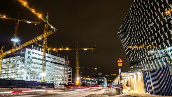 Time Lapse of construction site and reflective office building at night