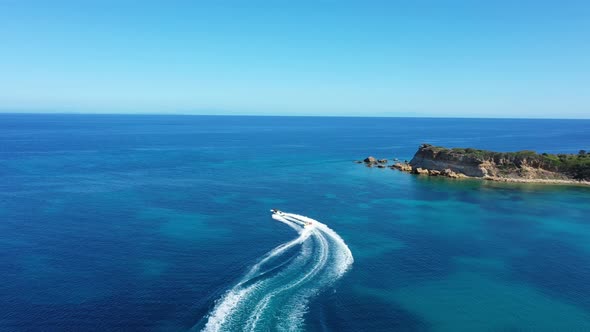 Aerial View of a Motor Boat Towing a Tube. Zakynthos, Greece