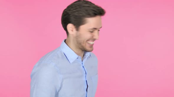 Dancing Young Man Isolated on Pink Background alt
