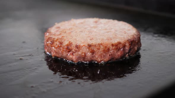 The Burger Meat Cutlet is Frying on Hot Grill at Restaurant Kitchen