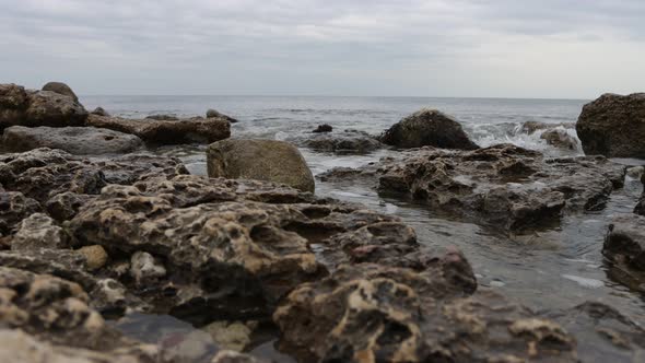 Wet Stony Coast Washed By Rippling Sea