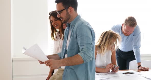 Coworkers Discussing New Ideas and Brainstorming in a Modern Office alt