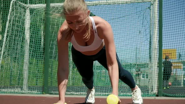 Young Athletic Caucasian Woman in Sportswear Doing Push Ups with Dumbbells