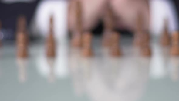 Chess Competition, Man in Suit Moving Pawn on Chessboard, Business Decision alt