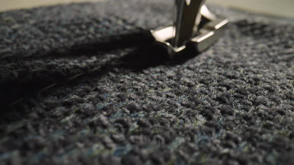 Movement of Foot and Needle While Sewing Gray Woolen Fabric with Sewing Machine alt