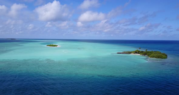 Wide above travel shot of a sunshine white sandy paradise beach and aqua turquoise water background  alt