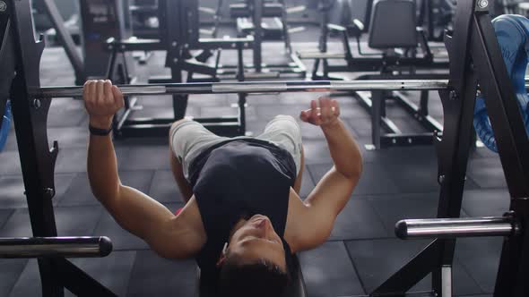 Professional Athlete Doing Bench Press Workout with a Barbell in the Hardcore Gym alt