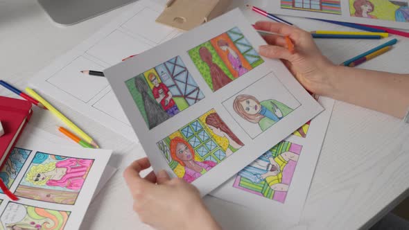 An illustrator artist draws a color storyboard on paper. Sketches for comics.