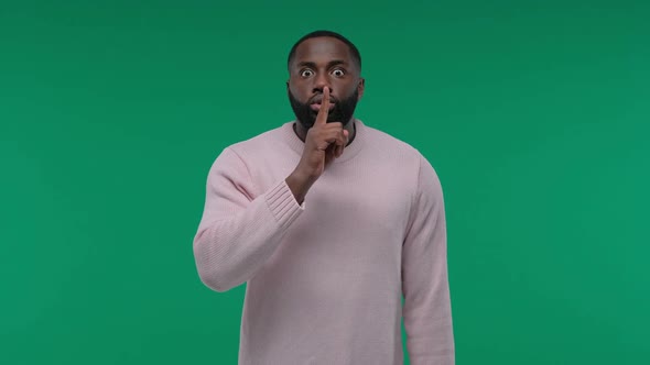 African American Man Showing Hush Gesture Isolated on Green Screen Chroma Key Background Keeping alt