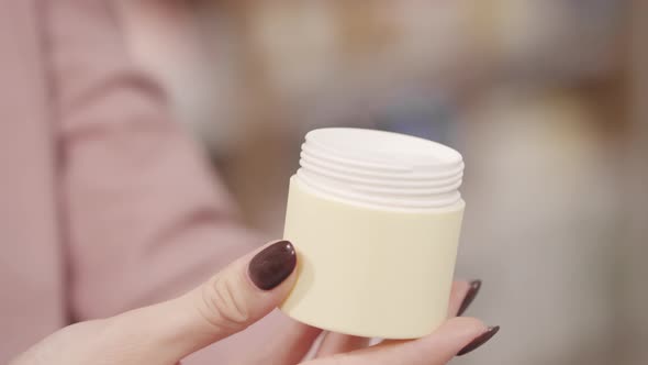 Unrecognizable Female Customer Trying Cream at Store alt