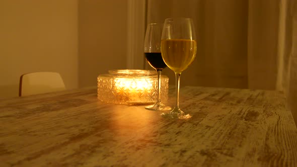 Glasses of red and white wine at candle light