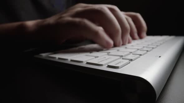 Close-up typing on keyboard with man fingers. Macro soft focus dolly shot. alt
