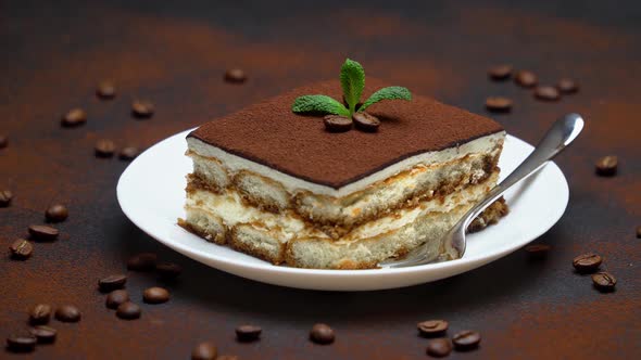 Portion of Traditional Italian Tiramisu dessert and coffee beans alt