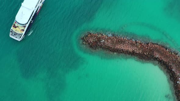 Drone view from above of ferry crossing clear water Seychelles