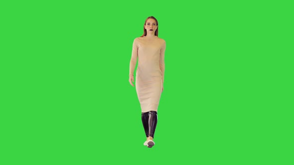 Robotic Girl in Beige Dress Walks Looking Straght Ahead on a Green Screen Chroma Key