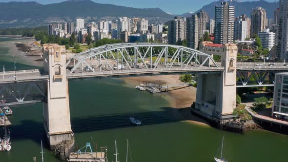 Aerial View Of Traffic Crossing Burrard Street Bridge With Waterfront Skyline In Background In BC, C alt