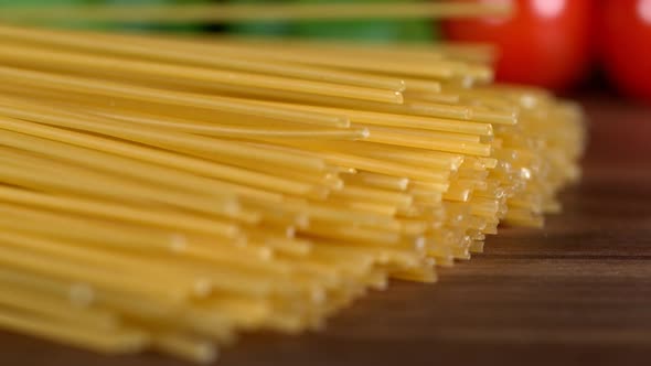 Super Slow Motion Shot of Fresh Spaghetti Falling on Italian Decorated Wooden Table at 1000Fps alt