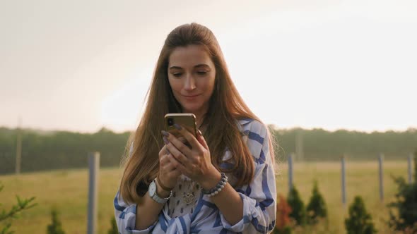 Portrait of Young Woman Using Mobile Phone Outdoor