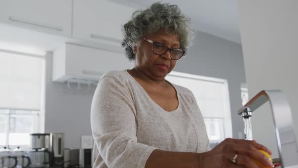 A senior african american woman spending time at home and cooking social distancing in quarantine. alt