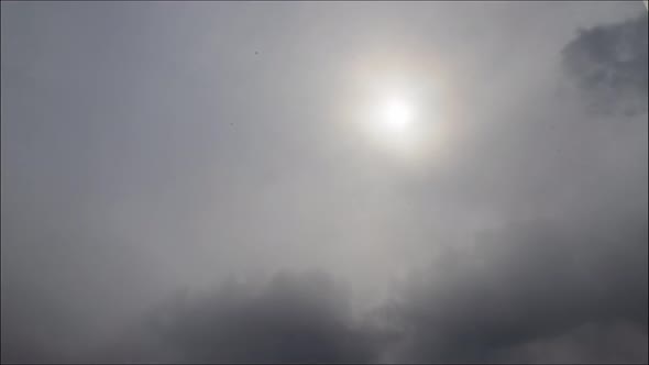 Time lapse: the sun shining through thik dense stormy snowing clouds. 4K