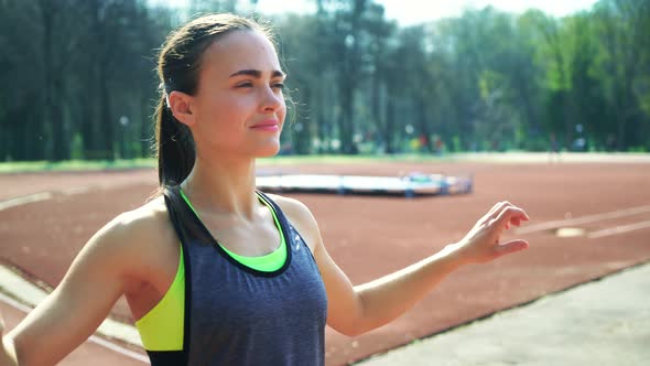 Track Runner Athlete Woman Warming up Before Running at a Stadium alt