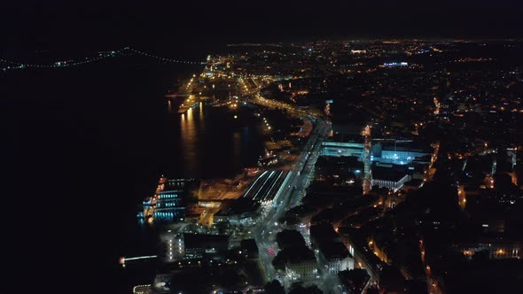 Stunning Night Aerial View of Houses and Ponte 25 De Abril Red Bridge in Urban City Center of Lisbon alt