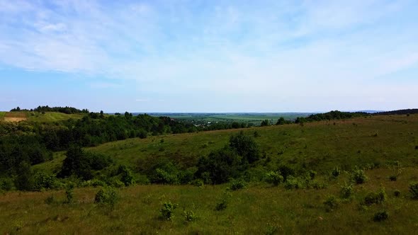 Aerial drone view of a flying over the rural agricultural landscape. alt