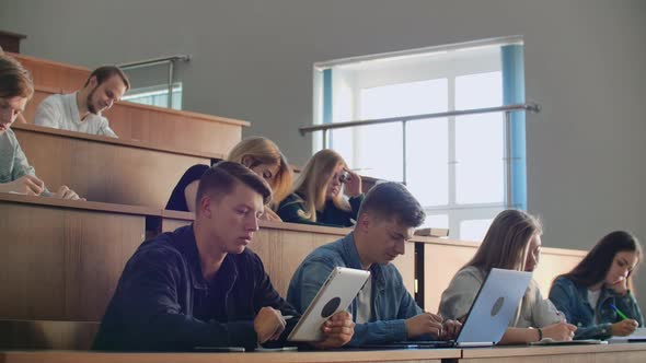 Modern Students Use a Laptop and a Tablet Computer for Lectures alt