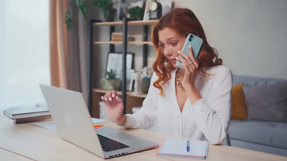 Successful Caucasian Woman Works on Computer and Speaks on Phone at Same Time alt