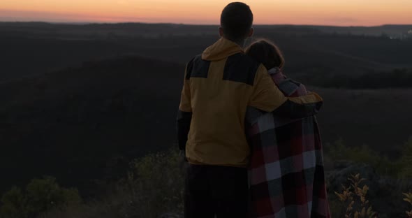 Two Travelers Man and Woman Spend Night Outdoors Couple Standing on the Edge of Hill and Enjoying alt