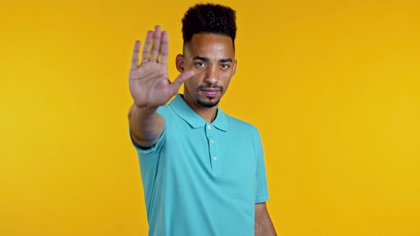 Portrait of Serious African American Man Showing Rejecting Gesture By Stop Palm Sign. Guy Isolated alt