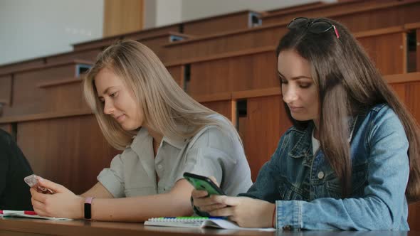 Multi Ethnic Group of Students Using Smartphones During the Lecture alt