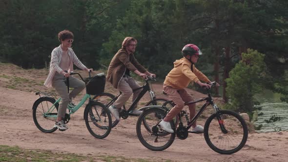 Family Cycling In Park alt