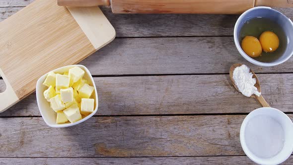 Butter cubes and egg yolk on a wooden table 4k alt