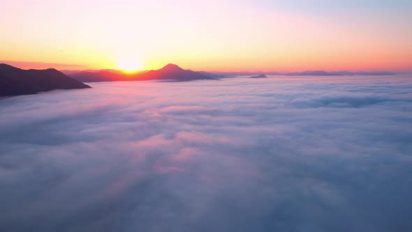 4K Aerial video Beautiful sunrise above dense clouds and fog in the morning alt