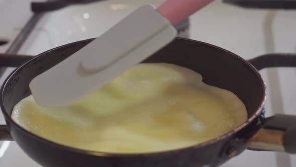 Cooking Pancakes in a Frying Pan Turning Over with a Silicone Spatula Biln