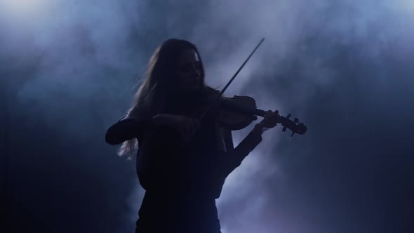 Young Beautiful Woman Playing a Melody on Violin, Smoky Dark Studio