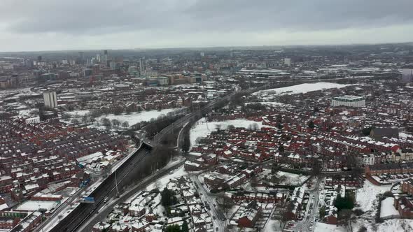 Aerial footage of a snowy winters day in the city of Leeds in the UK alt