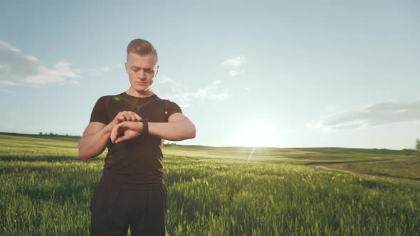 A Young Man in a Sports Uniform is Standing on the Field alt