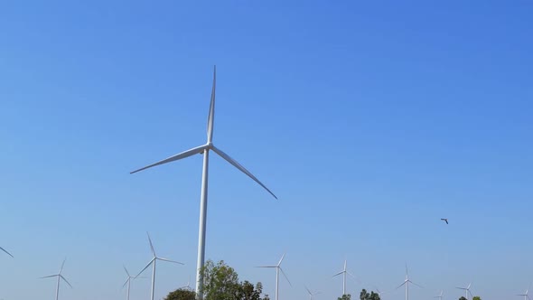 timelapse of Wind turbine producing alternative energy with blue sky