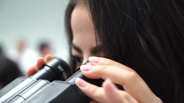 Female Medical Student With Microscope Closeup 4K alt